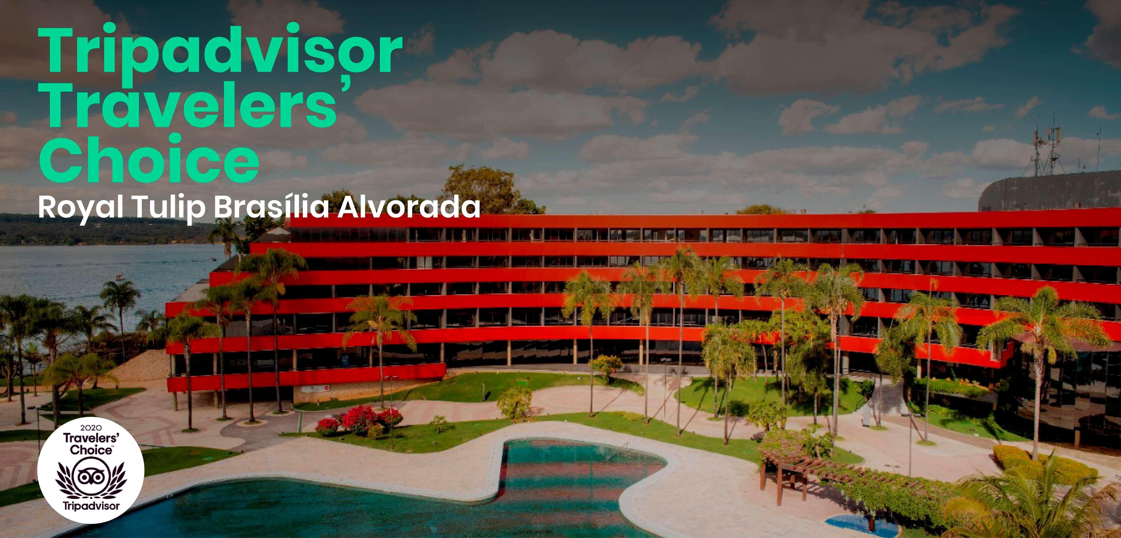 Royal Tulip Brasilia Alvorada Hotel Exterior photo The image shows a modern hotel or resort building with a distinctive red facade, surrounded by lush greenery and palm trees. In front of the building, there is a swimming pool that appears spacious and inviting. The setting looks tropical and relaxin